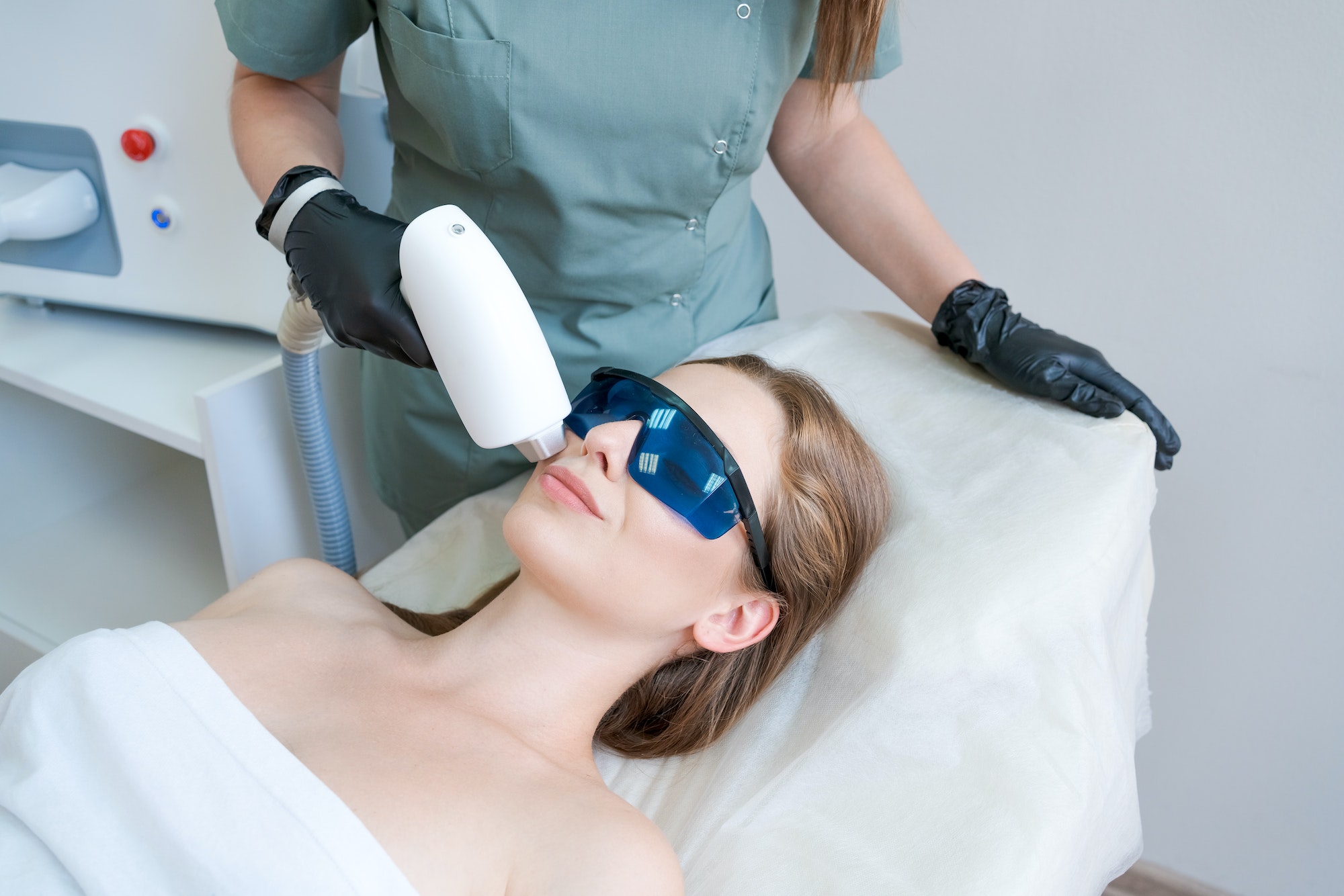 therapist-cosmetologist-undergoes-laser-treatment-on-face-young-woman-in-beauty.jpg