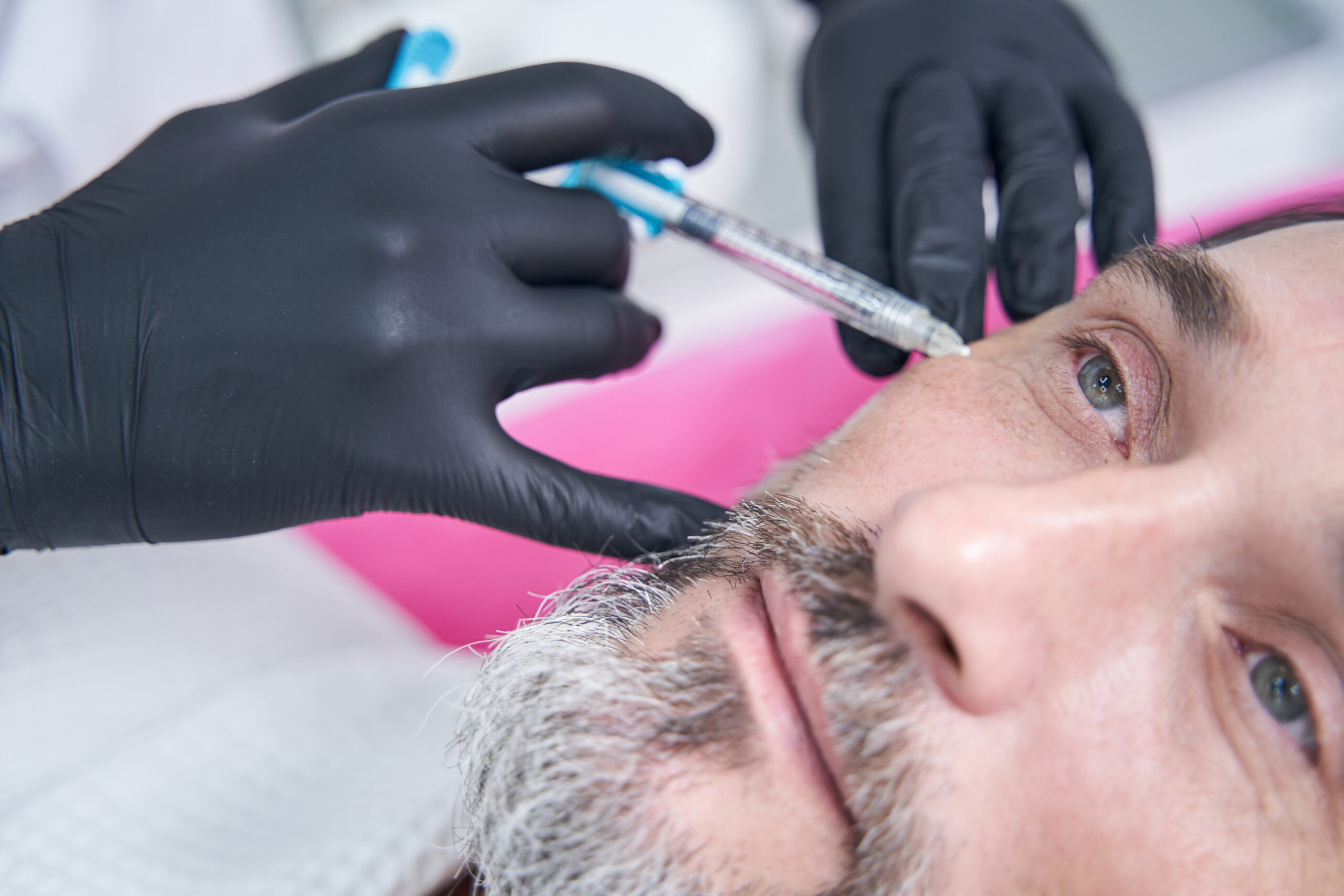 Focused photo on male person that being deep in his thoughts while being on procedure